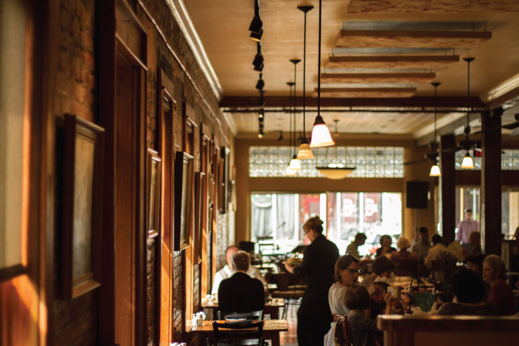 Guests dining in the warm, wood-trimmed dining room